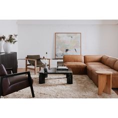 a living room filled with furniture and a painting