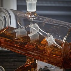 a glass bottle filled with liquid sitting on top of a table