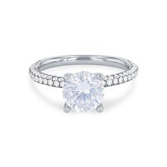 a white gold engagement ring with diamonds on the band and a round cut diamond in the center