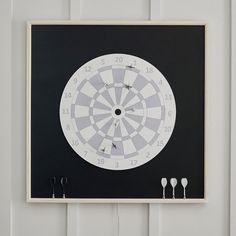 a dart board mounted to the side of a wall with three darts on each side