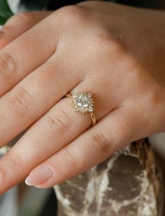 a woman's hand with a diamond ring on it