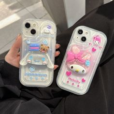 two cell phones with hello kitty cases on them