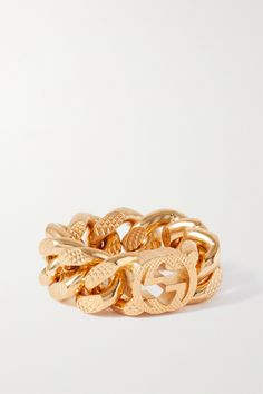 Gucci's gourmette chain was originally part of the 'Aria' collection. It reappears this season on jewelry and accessories like this gold-tone ring. The signature double-G crowns the piece. Designer Gold-tone Metal Jewelry, Gucci 14k Gold Designer Rings, Gucci Designer Rings In 14k Gold, Designer Gucci 14k Gold Rings, Gucci Fine Jewelry Ring, Gucci Formal Jewelry, Luxury Tarnish-resistant Chain Ring For Formal Occasions, Gold Luxury Chain Ring, Yellow Gold Metal Chain Ring