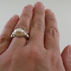 This ring has such a gorgeous genuine white pearl in the center! It is made with a potato shaped 7mm white cultured freshwater pearl wrapped with wire (sterling silver shown). The group picture at the end of the pictures shows all the gorgeous pearl colors I stock (white, brown and peacock). Each bead in the lot I received is slightly different, as mother nature intended, but equally beautiful. Your ring will receive a bead of the same quality as shown in the pictures. Use the options pull down Bridesmaid Ring, White Pearl Ring, Bridesmaid Rings, Group Picture, Ring Wire, Wire Wrapped Ring, A Potato, Diy Wire Jewelry, Custom Ring