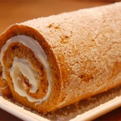 a pumpkin roll cake on a white plate