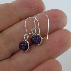 "Smooth purple amethyst 6mm beads, surrounded by sterling silver twist wire. Sweet! Small enough to wear every day, these earrings measure 7/8\" long including the sterling silver earwires. Amethyst is the February birthstone. This would make a perfect, affordable gift for that February girl, young or old! Also available in 14kt gold filled." Purple Dainty Earrings With Ear Wire, Dainty Purple Earrings With Ear Wire, Handmade Purple Sterling Silver Earrings, Elegant Purple Jewelry With Ear Wire, Everyday Purple Amethyst Earrings, Purple Gemstone Earrings For Everyday Wear, Dainty Nickel-free Purple Earrings, Amethyst Earrings For Gift, Dainty Purple Nickel-free Earrings