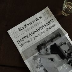 a newspaper with a photo of a couple hugging each other