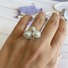 "Beautiful and unique Silver Wire Pearl Ring, ideal for an special gift for her,  This ring is made with a 3mm round pearl and wrapped in non tarnish silver wire. This ring is made to order in the size of your choice.  I T E M ~D E T A I L S Materials: Silver Plated Wire, Pearls. Size: See Variations. You can also ask for a different wire color, silver or rose gold tone are available (See variations). Thank you for visiting my product. You can see more amazing designs in my shop clicking here: h Handmade Adjustable Open Pearl Ring, Dainty Hand-wrapped Silver Rings, Adjustable Pearl Stackable Wedding Rings, Handmade Pearl Ring As A Gift, Adjustable Pearl White Pearl Ring As A Gift, Handmade Round Pearl Ring, Nickel Free Elegant Crystal Ring For Jewelry Making, Handmade Minimalist Pearl Ring For Wedding, Dainty Pearl White Ring As A Gift