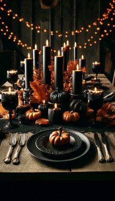 a table with candles and pumpkins on it