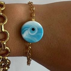 A unique bracelet withtiny colorful evil eyes and beads, a gold bangle bracelet with tiny eyes and, and a colrful bracelet with a unique light blue evil eye at the center. You can choose and wear them all together or separetely as well. Gold Spiritual Evil Eye Bracelet With Adjustable Chain, Blue Metal Bracelets With Evil Eye, Spiritual Blue Evil Eye Jewelry, Blue Metal Evil Eye Bracelet, Gold-plated Evil Eye Bracelet With Adjustable Chain, Blue Evil Eye, Gold Bangle Bracelet, Unique Bracelets, Unique Lighting