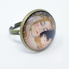 Cabochon Antiqued Brass Color Ring With Mother And Child Graphic Painting Wearable Art Adjustable Ring Size Mother’s Day Mama Mom Life Mom Gift Brand New Shop With Confidence Knowing That Every Item Is Hand Selected And Packaged With Care. Ships Next Business Day! Adjustable Nickel-free Rings For Mother's Day, Adjustable Hand Painted Rings For Gift, Adjustable Hand Painted Rings As Gifts, Unique Hand Painted Adjustable Rings, Artistic Hand Painted Ring Jewelry, Vintage Round Hand Painted Jewelry, Vintage Hand Painted Round Jewelry, Artistic Metal Ring Jewelry For Gifts, Artistic Open Ring Jewelry For Gifts