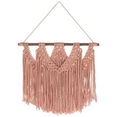 a pink macrame hanging on a wall