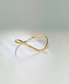 Very unique elegant curved thumb ring a perfect ring to add to your collection of jewelry. Sturdy and well designed for any occasion Very pretty on any finger!! Full round ring: 1.0mm thick ** Don't know your finger size? Print this: http://www.licketycut.com/printableringsizer.pdf SALE!! Great Value! **Dainty Rings On SALE Now** **100% Quality Guaranteed** --Thank you for stopping by. Please visit our new Etsy shop and view our other very unique Beautiful pieces of jewelry. --PLEASE FOLLOW -- - Minimalist Curved Gold Jewelry, Modern Gold Rings With Curved Design, Modern Twist Open Band Midi Rings As Gift, Modern Gold Curved Rings, Modern Curved Gold Rings, Minimalist Curved Yellow Gold Ring, Gold Curved Rings For Gifts, Gold Curved Rings For Gift, Curved Gold Rings For Gifts