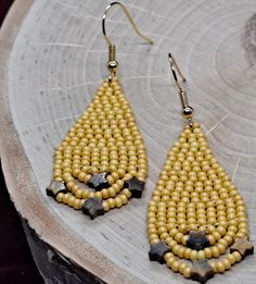 Handmade teardrop shaped sead bead earring - Yellow with star shaped Tiger's Eye gemstones - 3/4 inches wide by 2 1/4 inches long - Lightweight - Fun - Nickel free ear wires (Stainless steel on request) - Synthetic thread - Handmade by me for you Be sure to check out my other handmade items  https://lesliesjewelryco.etsy.com Handmade Yellow Bohemian Teardrop Earrings, Yellow Chandelier Drop Earrings With Dangling Beads, Yellow Beaded Teardrop Earrings, Yellow Teardrop Beaded Earrings With Dangling Beads, Yellow Beaded Teardrop Jewelry, Yellow Teardrop Beaded Earrings As Gift, Yellow Teardrop Beaded Earrings For Gift, Yellow Teardrop Beaded Jewelry, Handmade Yellow Star Jewelry