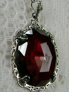 Red Garnet CZ (Cubic Zirconia) Sterling Silver Victorian PendantBubble Design#P10 Transform your wardrobe with the Bubble Pendant P10! This stunning antique reproduction necklace is lovingly handcrafted in sterling silver, with a faceted Garnet CZ gemstone in 22-carat sparkle. The perfect accessory for an elegant look, this pendant is sure to become your go-to jewelry piece. Taking inspiration from classic Victorian era designs, it will complete your outfits with attractive style and classic sop Red Gothic Necklace For Formal Occasions, Red Victorian Necklace For Anniversary, Red Pendant Jewelry For Formal Occasions, Elegant Red Garnet Necklaces, Elegant Red Garnet Necklace, Elegant Red Jeweled Necklace, Red Jewel-encrusted Jewelry For Formal Occasions, Formal Red Garnet Jewelry, Red Jeweled Jewelry For Formal Occasions