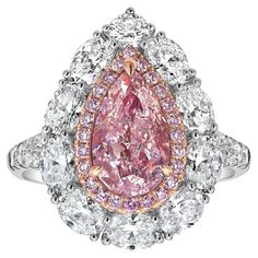 This exquisite piece features a 2.01 carat GIA-certified Very Light Pink diamond at its center, with I1 clarity. Surrounded by 1.70 carats of sparkling diamonds, the design showcases a delicate yet luxurious look. Handcrafted in 18k white gold, this ring exudes elegance with a contemporary twist. One of its standout features is the detachable head, allowing it to be worn as a pendant for added versatility. Whether worn as a ring or a pendant, this piece seamlessly adapts to your style, making it Gia Certified Moissanite Diamond Ring, Pear-shaped, Gia Certified Moissanite Pear-shaped Diamond Ring, Luxury Pear-shaped Diamond Ring With Halo Setting, Exquisite Pear-shaped Diamond White Diamond Ring, Elegant Gia Certified Pear-shaped Diamond Ring, Gia Certified Luxury Pear-shaped Jewelry, Dazzling Pear-shaped Gia Certified Rings, Luxury Gia Certified Pear-shaped Rings, Luxury Pear-shaped Gia Certified Rings