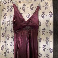 Eureka Dark Maroon Formal Gown With Gorgeous Beading And Jewels On Both Sides. Formal Dresses With Beaded Straps For Prom Season, Evening Dresses With Beaded Straps And Fitted Bodice, Silk V-neck Dress For Prom Season, Formal Embellished Satin Dresses, Purple Embellished Gown For Formal Events, Formal Satin Embellished Gown, Silk Sleeveless Dress With Sweep Train, Festive Sleeveless Satin Dress, Silk V-neck Prom Gown