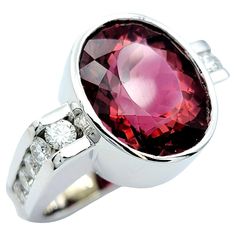 Ring size: 4.5 Elevate your fine jewelry collection with this stunning Scott Gauthier rubellite tourmaline & diamond ring. This contemporary masterpiece effortlessly blends sophistication with modern design, making it a true showstopper. At the heart of this ring, you'll find a captivating oval rubellite tourmaline, a vibrant gemstone that radiates a rich, deep pink hue. This stunning centerpiece is expertly bezel set in 14 karat white gold, allowing the pink to really pop. Flanking the rubellit Multi Gemstone Ring Jtv, Rubellite Tourmaline, Modern Ring, Contemporary Aesthetic, Channel Set, Fine Jewelry Collection, Diamond Clarity, Cocktail Rings, Colored Diamonds