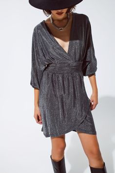 Introducing our Silver Glitter Dress with Deep V Neck – a stunning and versatile piece designed to make you stand out at parties and special occasions. This mini-length dress features a deep V-neck neckline, long sleeves, and a relaxed fit, ensuring both style and comfort for a flattering look on all body types.  Crafted from a blend of 51% polyamide, 44% metal, and 5% elastane, this dress showcases a metallic finish that adds a touch of glamour to your ensemble. The zip-back fastening ensures easy wear, making it a convenient and stylish choice for various events.  The S-M-L sizing corresponds to US sizes 4, 6, and 8 respectively, providing options for a comfortable fit. Our model, with measurements of 32-23-35 and a height of 5', wears size S, showcasing the relaxed fit and the overall c Silver Glitter Dress, Dress With V Neck, Glitter Mini Dress, Chic Party, Glitter Dress, Style Party, Fit Style, Party Fashion, Silver Glitter