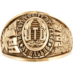 a gold ring with the university of texas seal on it's center and two letters in