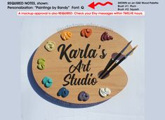 a wooden sign that says karla's art studio with paintbrushes on it