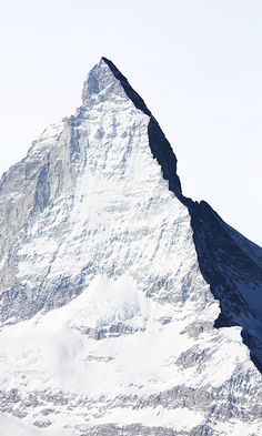 a snowboarder is standing in front of a mountain