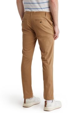 A solid hue makes these chino pants a versatile, everyday classic staple for your closet. 9" rise, 32" inseam (size 32x32) Trim fit Zip fly with button closure 2 front slash pockets; 2 back button welt pockets 97% cotton, 3% spandex Machine wash, tumble dry Imported Slim Fit Chinos With Welt Pockets For Fall, Slim Fit Straight Leg Solid Chinos, Solid Color Slim Fit Straight Leg Chinos, Slim Fit Straight Leg Chinos, Solid Color Straight Fit Cotton Bottoms, Fitted Chinos With 5-inch Inseam And Pockets, Casual Fitted Straight Chinos, Fitted Straight Chinos In Casual Style, Solid Color Relaxed Fit Straight Leg Chinos