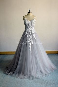 a gray wedding dress with white flowers on it