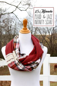 a white mannequin wearing a red and black plaid scarf