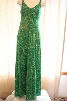 Fun green and white paisley long true vintage dress. The tag says "Olga" Great condition. The 100% nylon Fabric has a little stretch. The bodice is lined and there is a matching tie at the empire waist. Bust measured at under arms 29 inches Empire waist 3 1/2 inches below under arms 27 inches Hips measured 15 inches below under arms 28 inches Length from top of strap to bottom of him 54 inches Green Lined Fitted Maxi Dress, Green Casual Paisley Print Maxi Dress, Casual Green Paisley Print Maxi Dress, Fitted Green Maxi Dress With Empire Waist, Fitted Green Dress With Empire Waist, Casual Fitted Maxi Dress With Paisley Print, Fitted Paisley Print Sundress, Spokane Wa, Nylon Fabric