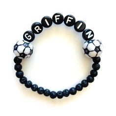 Sports themed name bracelets are great gifts for your favorite player or for sports themed bday party favors! Choose baseball, basketball or soccer beads, add a name, and we'll do the rest! The lava beads are 4mm. Please check all selections and spelling prior to check out. Our custom bracelets are made to order so all sales are final. The bracelets are beautifully packaged and ready to gift. Receipts are never included. Roll, don't pull. To avoid excess stretching please roll the bracelet on an Team-colored Bracelets With Letter Beads For Sports, Team-colored Sports Bracelets With Letter Beads, Team-colored Letter Beads Bracelets For Sports, Team Spirit Letter Beads Wristband For Game Day, Team Spirit Wristband With Letter Beads For Game Day, Sporty Beaded Bracelets In Team Colors For Sports Events, Sporty Team-colored Beaded Bracelets For Sports Events, Sporty Beaded Bracelets With Letter Beads For Team Events, Sporty Beaded Bracelets With Letter Beads For Sports Events