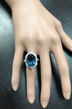 12.75 Carats Natural Impressive LONDON BLUE TOPAZ and Diamond 14K White Gold Ring Suggested Replacement Value $6,200.00 Total Natural London Blue Topaz Weight: Approx. 12.00 Carats London Blue Topaz Measures: Approx. 15 x 11mm Natural Round Diamonds Weight: .75 Carats (color G-H / Clarity SI1-SI2) Ring total weight: 9.0 grams Disclaimer: all weights, measurements and colors are approximate and may vary slightly from the listed dimensions or as seen in the image. All pictures are magnified to sho Luxury Cushion Cut Diamond Topaz Ring, Elegant Topaz Ring With Gemstone Accents For Anniversary, Luxury Diamond Topaz Ring With Cushion Cut, Luxury Blue Topaz Cushion Cut Ring, Elegant Blue Emerald Cut Gemstones, Luxury Diamond Ring With Gemstone Accents For Anniversary, Luxury Blue Diamond Ring With Accents, Elegant Topaz Ring With Cubic Zirconia Accents, Luxury Blue Topaz Jewelry