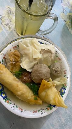 a white plate topped with food next to a drink