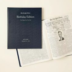 an open book sitting on top of a table next to a paper with the words birthday editor