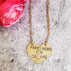 "Celebrate your friendship with this funny jewelry set for two! These are TWO beautiful broken heart necklaces hand-stamped as one with the phrase, \"PARTNERS IN CRIME\" in uppercase or lowercase font of your choice. When the necklaces are apart, the message on the full necklace isn't clear -- which is great for those of us who love to laugh at ourselves. Show your appreciation for your ride or die, partner in crime! This pair of accessories is a fantastic gift for your best friend for their bir Heart Pendant Charm Necklaces For Friendship And Valentine's Day, Heart Pendant Charm Necklaces For Valentine's Day, Valentine's Day Stainless Steel Necklace, Personalized Double Heart Necklaces For Friendship, Personalized Couples Necklaces For Anniversary, Personalized Couples Necklaces For Anniversary Gift, Personalized Double Heart Friendship Necklace, Couples' Heart Charm Jewelry For Gifts, Double Heart Charm Necklace Valentine's Day Gift