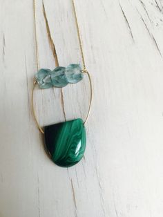 A refined slab of Malachite is blended with vintage glowing aqua glass and woven into this one of a kind statement necklace. Length is 24 inches Pendant size 2 inches MATERIAL: GOLD-FILLED - 14k Gold filled is considerably durable and considered a lifetime piece of jewelry. This is NOT gold plated or gold dipped vermeil jewelry which can chip off over time with wear. Gold filled metal is essentially a 14k gold tube filled with an inner core metal such as brass and has been mechanically bonded wi Malachite Necklace, Aqua Glass, Inner Core, Vermeil Jewelry, Necklace Gemstone, Necklace Statement, Gold Dipped, Gold Filled Jewelry, Glass Necklace