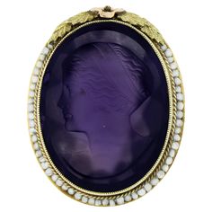 This rare antique art deco ring was crafted from solid 14k yellow & green gold with rose gold accents. It features a detailed carved amethyst left facing cameo neatly bezel set at the center of the ring. The outstanding carving shows a detailed portrait of a woman and is absolutely wonderfully framed by Milgrain, twisted wire & seed pearls. The ring is further engraved with delicate scroll work on the side shoulders and is decorated with a daisy flower & leaves at the top of the frame. This is a Antique Cocktail Ring, Detailed Portrait, Antique Jewelry Rings, Amethyst And Diamond Ring, Rose Gold Accents, Deep Purple Color, Flower Leaves, Scroll Work, Cameo Ring