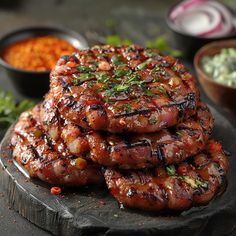 several sausages stacked on top of each other with sauce and seasoning around them