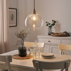 a dining room table with plates and vases on it