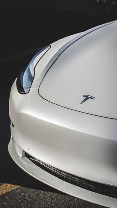 the front end of a white sports car