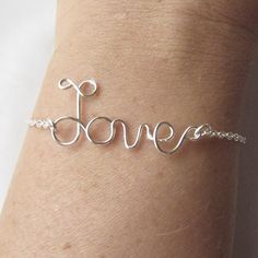 "This dainty bracelet features \"love\" written in non-tarnish silver plated wire.  It measures 7 inches (19 cm) long and closes with a lobster claw. I can also make it in any size and in-between size you need. Please include your size in the comments to seller. Please check my policies and contact me for any questions. All packages will be shipped within 1-5 business days after payment complete Items will be send priority air mail ( not traceable) allow 10-18 days for delivery." Inspirational Sterling Silver Friendship Bracelets, Sterling Silver Wire Wrapped Bracelets As Gift, Inspirational Sterling Silver Nickel-free Bracelets, Silver Inspirational Bracelets For Valentine's Day, Inspirational Silver Bracelets For Valentine's Day, Meaningful Silver Name Bracelet, Handmade Inspirational Silver Bracelets, Word Bracelet, Wire Jewelry Designs