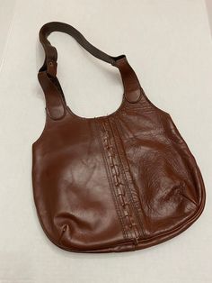 "Vintage leather shoulder bag, has a fun stitch up the center, pocket inside...very 70's boho! Maker/Brand: Don Quixote, New York, Made in Dominican Republic Year: 1970's Measurements: 12 1/4\" x 9 3/4\" plus another 11 1/2\" for strap Color: Brown, slightly red tinge Material: Leather, vinyl, metal Condition: Vintage, pre-owned All vintage is sold in \"as-is\" condition. We do our best to list any flaws. Purse is in good condition. Leather does have some crinkling to it on the front. Please see Retro Satchel Shoulder Bag With Pockets, Retro Vintage Brown Soft Leather Bag, Vintage Brown Retro Crossbody Shoulder Bag, Retro Vintage Brown Crossbody Shoulder Bag, Vintage Soft Leather Hobo Shoulder Bag, Retro Crossbody Shoulder Bag With Pockets, Vintage Soft Leather Hobo Bag, Retro Brown Leather Shoulder Bag, Retro Soft Leather Crossbody Shoulder Bag