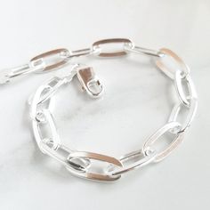 Details:  - one (1) solid sterling silver chain-link bracelet - fits wrists 7.5" and under  - each link is 1/4" x 1/2" Add a charm to the bracelet with this listing: https://www.etsy.com/listing/562251733/add-on-charm-for-necklaces-or-expandable?ref=shop_home_active_1&pro=1 » DON'T FORGET TO GRAB A SUNSHINE POLISHING CLOTH: https://www.etsy.com/listing/469627127/sunshine-cleaning-cloth-for-jewelry?ref=shop_home_active_1 » CHECK OUT MY ENTIRE SHOP https://www.etsy.com/shop/TatumBradleyCo?ref=si_s Chunky Silver Jewellery, Chunky Silver Bracelet, Silver Gold Jewelry, Silver Bracelets For Women, Chic Bracelet, Toggle Bracelet, Engraved Bracelet, Birthday Gifts For Women, Silver Jewellery