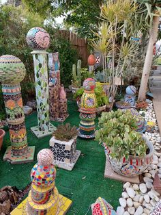 a garden filled with lots of different types of vases and plants on top of green grass