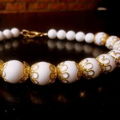 "This necklace is made of rare white coral stone ornamented with gold plated floral filigree pieces, wrapping the coral beads. It gives the necklace an antique look. This necklace will work for everyday or with an evening dress. Dimensions: length - 20\" coral stones approx. diameter - 2 cm , 1.4 cm for the small beads in the back of the neck. extender - an extension chain can be added by request *If, for any reason, you are not completely satisfied, please contact me so we can try to work out t Traditional White Beaded Formal Necklace, Traditional White Beaded Necklace For Formal Events, Traditional White Beaded Necklace For Formal Occasions, Luxury White Jewelry For Ceremonial Occasion, Exquisite White Filigree Necklaces, Exquisite White Filigree Necklace, Luxury White Beaded Jewelry, Vintage White Jewelry For Ceremonial Occasions, Ornate White Ceremonial Jewelry