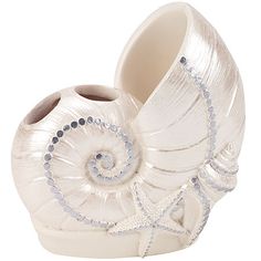 a white vase with a seashell design on it