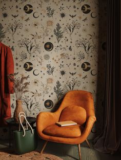 an orange chair sitting in front of a wallpapered with stars and moon designs