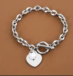 Stylish silver chain link charm heart bracelet  Great gift for birthday, anniversary, child, friend, and any occasion  Built for durability and long lasting wear. Silver Heart Charm Bracelet For Friendship, Metal Charm Bracelet With Heart Charm For Mother's Day, Silver Stainless Steel Heart Bracelet For Friendship, Mother's Day Metal Charm Bracelet With Heart Charm, Mother’s Day Metal Charm Bracelet With Heart Charm, Trendy Personalized Silver Heart Bracelet, Mother's Day Heart-shaped Metal Charm Bracelet, Heart Chain Bracelet As Gift, Heart-shaped Chain Bracelet As A Gift