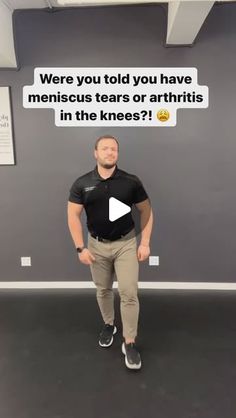 a man standing in front of a wall with an ad on it that says, were you told you have meniscus tears or arthris in the knees?