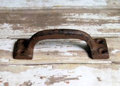 an old rusted iron handle on a wooden door